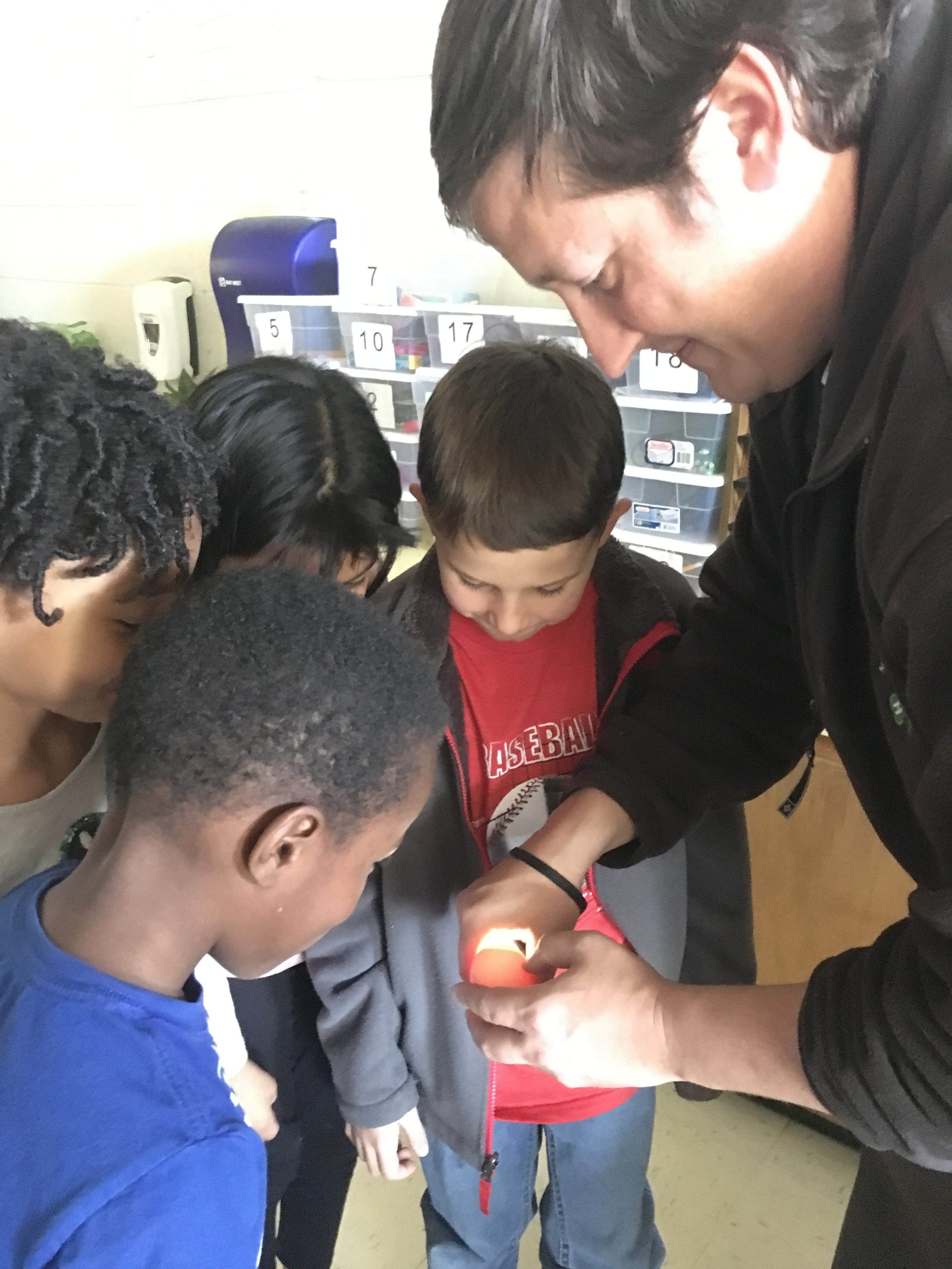 Kids looking at egg